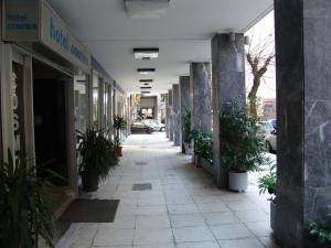 an empty street with potted plants in a building at Hotel Cosmos in Athens
