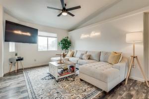 a living room with a couch and a flat screen tv at Family Friendly Home w/ Backyard Games, RV Parking in Lake Havasu City