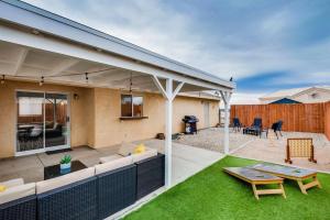 a backyard with a patio with a table and a fence at Family Friendly Home w/ Backyard Games, RV Parking in Lake Havasu City