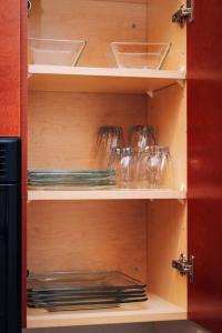 a cabinet with empty shelves with bowls and plates at Cozy Stylish Downtown Loft in Saint Louis