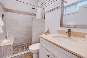 a bathroom with a sink and a toilet at Unit 8 Maui Ohana Modern Studio in Wailuku