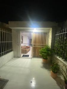 a room with potted plants and a window at night at Apartamento En Los Ángelesツ in Santa Marta