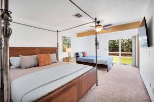 a bedroom with a large bed and a fan at Centrally located Spacious Vacation Hom 13 m strip in Las Vegas