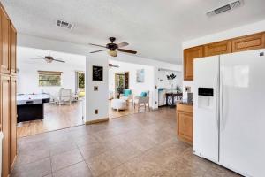 a kitchen and living room with a white refrigerator at Centrally located Spacious Vacation Hom 13 m strip in Las Vegas