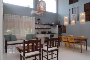 a kitchen and dining room with a table and chairs at MUNI MUNI VILLAS SIARGAO in General Luna