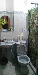 a bathroom with a toilet and a sink at Charming Getaway @ The City of Pines in Baguio