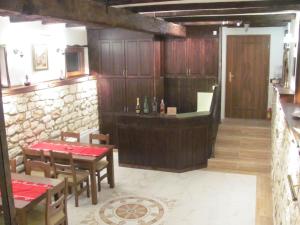 a restaurant with wooden walls and tables and chairs at Guest House Villa Elma in Nevsha