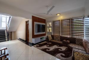 a living room with a couch and a tv at Nyali Villa in Mombasa