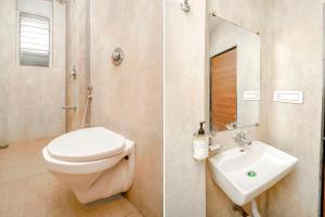 a bathroom with a toilet and a sink at FabHotel Mahadev Residency in Kolshet