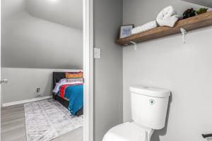 a bathroom with a toilet and a bed in a room at 3rd Story Loft next to West Village Free Parking in Detroit