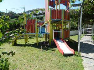 a playground with a slide in a park at Hotel Glicorisa Beach in Pythagoreio