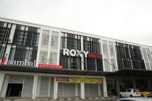a building with a ryoy music sign on it at Roxy Hotel Aiman in Kuching