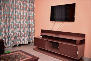 a living room with a flat screen tv on a wall at Nova Homes in Thika