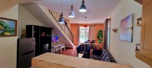 a living room with a kitchen and a dining room at Residence Le Choisy in Mont Choisy