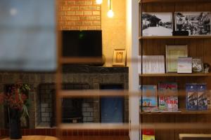 a living room with a fireplace and a tv at Hotaru no Yado - Vacation STAY 24964v in Sumoto