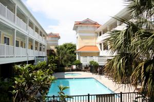 a view of the courtyard of a hotel with a swimming pool at The Dunes in Oak Island