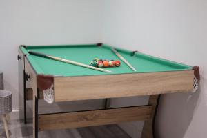 a pool table with two cue balls on it at 5 Bed Town House Within City Centre and Sleeps Up To 11 with Sky and Netflix in Birmingham