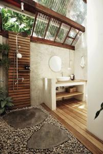 a bathroom with a shower and a sink and a mirror at Banyan Villa Panglao with private pool in Panglao
