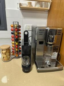a kitchen counter with a coffee maker and a blender at הפינה בנחל in HaGoshrim
