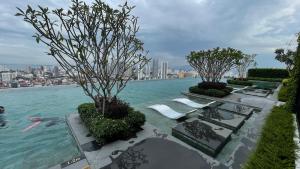 a view of a pool of water with benches and trees at Beacon Executive Suites #Georgetown #RoofTopPool #Spacious #13a in George Town