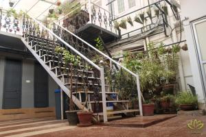a staircase with plants on the side of a building at Aambal Residency in Cochin