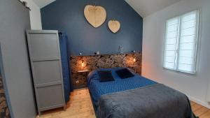 - une chambre avec un lit et deux cœurs sur le mur dans l'établissement Les Appartements du 104, à Saint-Jean-de-Monts