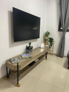 a living room with a flat screen tv on a wall at הפינה בנחל in Hagoshrim