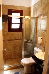 a bathroom with a shower and a toilet and a sink at Villa Irini in Spetses