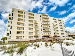 a building on the beach next to the sand at Carefree 108 in Pensacola Beach