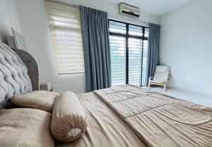 a bedroom with a large bed with a large window at Rania D'Mawar Homestay 2 1/2 Tingkat KLIA in Sepang