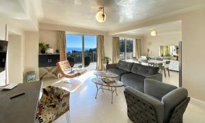 a living room with a couch and a table at Taormina Skyline in Taormina