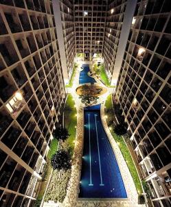an overhead view of a pool between two tall buildings at SHORE RESIDENCE D13 shortwalk Mall of asia near airport in Manila
