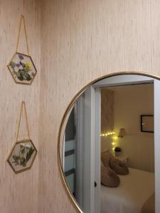 a mirror on a wall with a bed in a room at "COZY LOFT", TERRACE, PARKING and SWIMMING POOL in Málaga