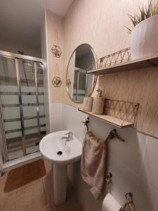 a bathroom with a sink and a mirror at "COZY LOFT", TERRACE, PARKING and SWIMMING POOL in Málaga