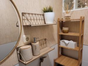 a bathroom with a mirror and shelves and a sink at "COZY LOFT", TERRACE, PARKING and SWIMMING POOL in Málaga