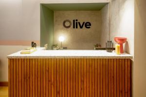 a kitchen with a counter top with the words live on the wall at Olive Golflinks - by Embassy Group in Bangalore