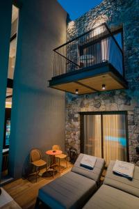 a living room with a couch and a balcony at Capital Luxury Suites in Nafplio