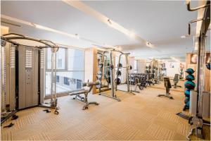 a gym with a row of treadmills and machines at Libra Hotel Nha Trang in Nha Trang