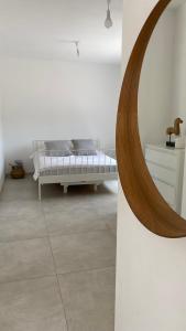 a bedroom with a bed and a mirror on a wall at אירוח ליד אילת compliment near Eilat in Beʼer Ora