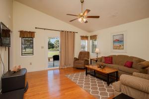 a living room with a couch and a table at 9th Tee in Caswell Beach