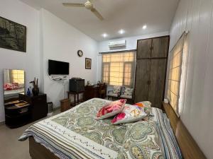 a bedroom with a bed with two pillows on it at Luxurious Homestay- Chandīgarh in Chandīgarh