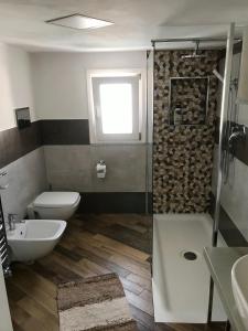 a bathroom with a shower and a toilet and a sink at Ballarò Holiday in Palermo