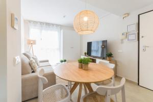 a living room with a table and a couch at Beach & Port in Gandía