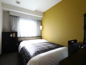 Ένα ή περισσότερα κρεβάτια σε δωμάτιο στο APA Hotel Roppongi Ekimae