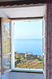 a window with a view of the ocean at Can Busquets in Banyalbufar