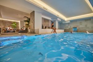 a woman in a hotel swimming pool at Palazzo Doglio in Cagliari