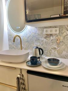 a bathroom counter with a sink and two cups at Small Private Studio in heart of Valencia - Rusafa in Valencia