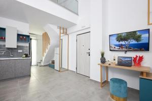 a kitchen with a counter and a table in a room at GreyStoneApartments in Paralia Dionysiou
