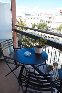 a blue table and chairs on a balcony at Adrian Hotel in Athens