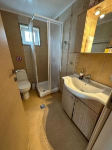 a bathroom with a toilet and a sink and a shower at 7ο_seahome in Alexandroupoli